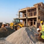 Sand Price Today in Pakistan with sand piles at a house construction site and workers inspecting materials.