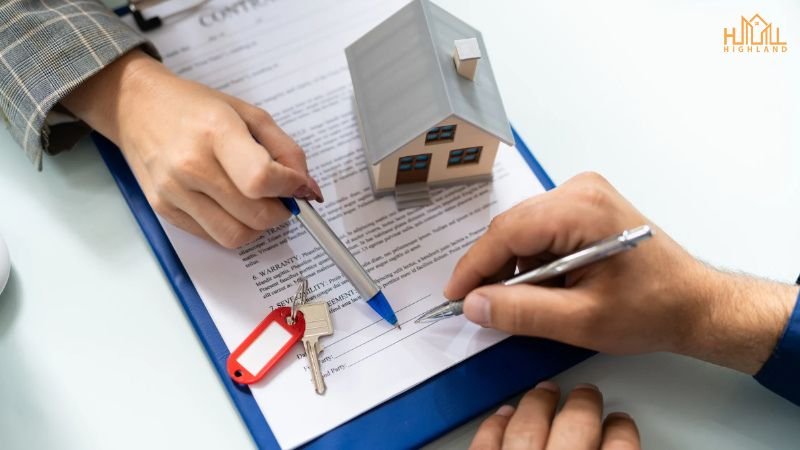 Close-up of a real estate contract being signed, with a miniature house and keys symbolizing home ownership and construction financing in Lahore.

