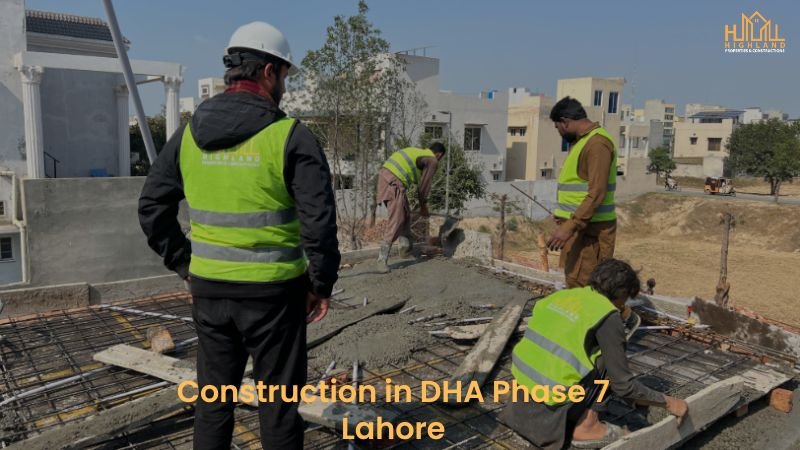 Ongoing construction in DHA Phase 7 Lahore, with workers and engineers actively working on a grey structure under development.