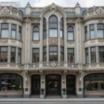 Art Nouveau style building featuring ornate facades, curved balconies, and decorative ironwork.