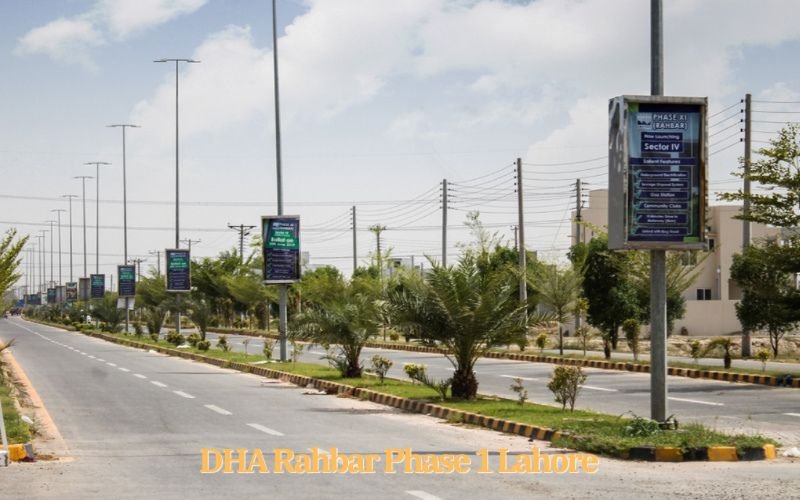 Wide road view with palm trees and modern street lights in DHA Rahbar Phase 1, Lahore.
