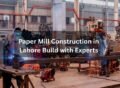 Workers welding steel structures inside a factory during paper mill construction in Lahore.