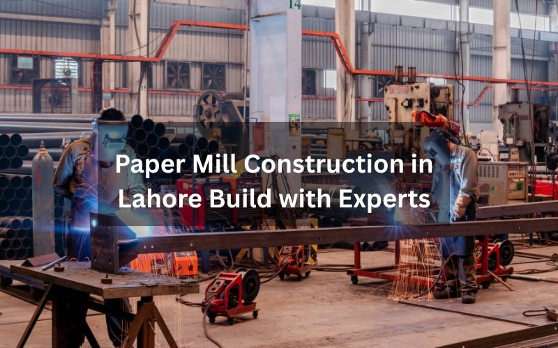 Workers welding steel structures inside a factory during paper mill construction in Lahore.