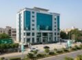 Modern bank building in Pakistan featuring glass façade and commercial architecture an example of high-quality bank building construction in an urban area.