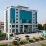 Modern bank building in Pakistan featuring glass façade and commercial architecture an example of high-quality bank building construction in an urban area.