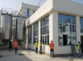 Engineers and workers inspecting a modern food processing facility under construction by a Food Industry Construction Company in Lahore.