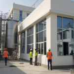 Engineers and workers inspecting a modern food processing facility under construction by a Food Industry Construction Company in Lahore.