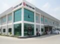 Modern textile and stitching unit building in Pakistan with glass front and industrial architecture representing a leading textile & stitching units construction company in Pakistan.