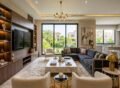 Luxury modern living room interior design with stylish furniture setup showcasing Furniture Solutions in Bahria Town Lahore, featuring sofa set, wooden wall unit, and elegant décor in a bright contemporary home.