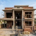 Modern house under construction showing a strong grey structure with workers on site, representing Grey Structure Construction in Park View City Lahore.