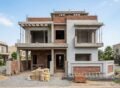 Modern House Construction in Fazaia Housing Scheme Lahore with a double-story grey structure in the finishing phase.