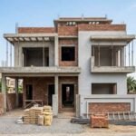 Modern House Construction in Fazaia Housing Scheme Lahore with a double-story grey structure in the finishing phase.