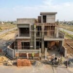 House Construction in Jubilee Town Lahore showing a modern residential building under construction with workers, scaffolding, and brickwork in progress.