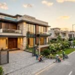 Modern luxury house under construction in a premium residential community, showcasing high-end architecture, landscaped frontage, and professional workmanship, highlighting Turnkey Construction in DHA Lahore.