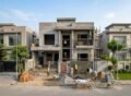 Construction Cost for a modern house under construction with workers on site.