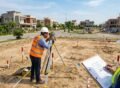 Site Survey Before House Construction with engineers measuring and marking a residential plot.